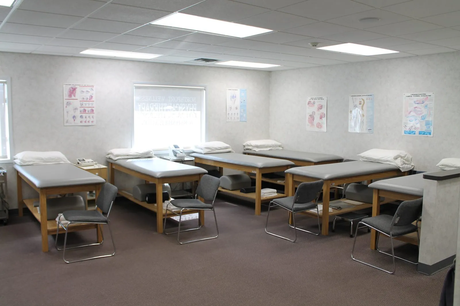 Treatment room with rows of padded tables